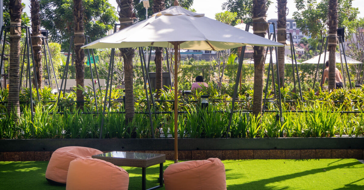 Many colourful bean bag seats on grass outdoors 